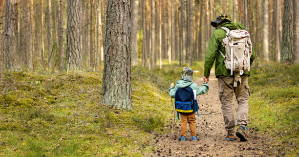 istock father and son on a adventure hike in forest. bonding activities, nature explore 1396846032