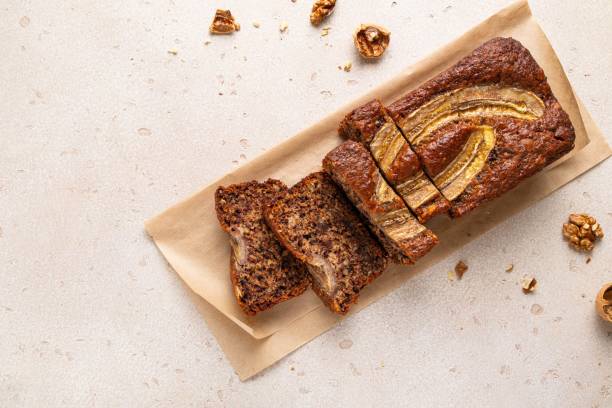 pan de plátano casero tradicional americano en rodajas con nueces picadas, chocolate y canela sobre fondo claro. tarta de frutas. pastel. fondo del desayuno. vista superior, espacio de copia. - pound cake fruitcake cake loaf of bread fotografías e imágenes de stock