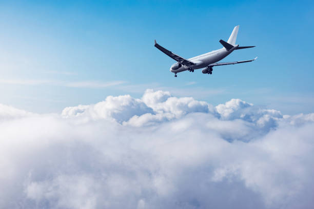 istock Flight of the passenger plane above the clouds. 1396846156