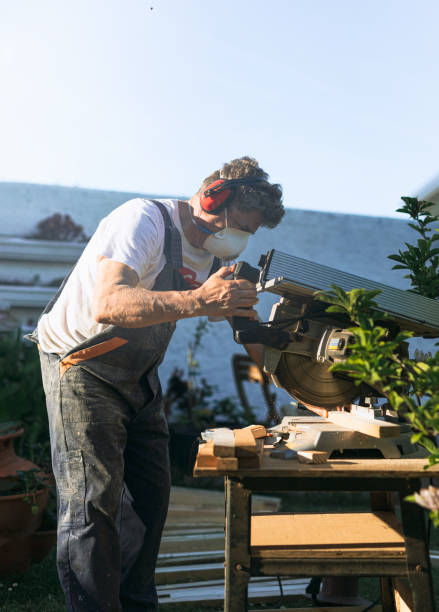 istock man cutting wood with a saw 1396849515