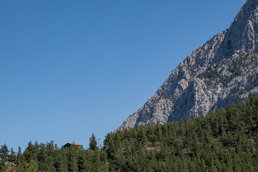 House in woodland clear sky background steep mountain landscape photo mediterranean region