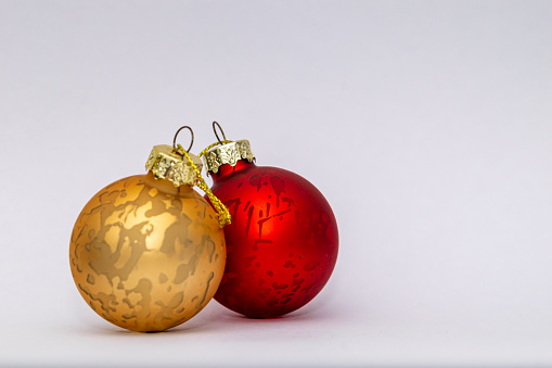 A pair of gold and red Christmas festive baubles isolated on a white background desktop wallpaper