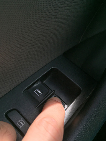 Opening car window, finger pushing car window push button
