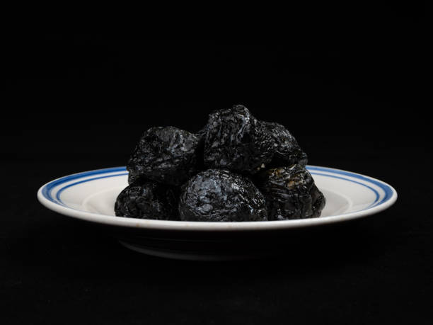 istock Chinese Smoked Plum on Black Background 1396853049