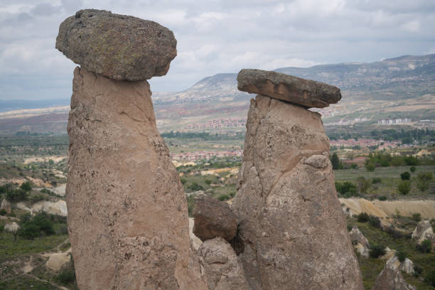 Photo of chimney rock structures in Cappadocia, Turkey. No people are seen in frame.