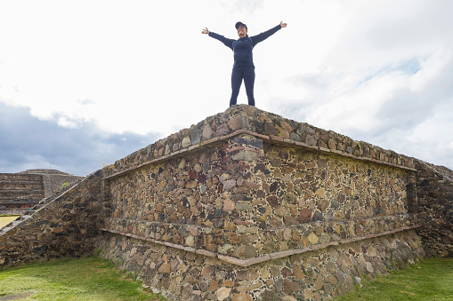 Woman with open arms in Teotihuacan ruins, Mexico