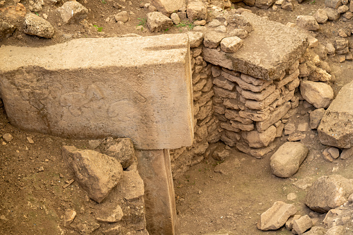 Close up photo of stone pillars in Gobekli Tepe. No people are seen in frame. Shot under day light.