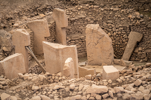 Photo of ruins of Gobekli Tepe rock construction. No people are seen in frame. Shot under day light.