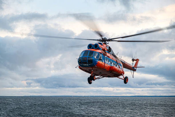 istock The helicopter lands on the deck with a hover. A training flight with a training landing on the helipad of a moving ship. 1396855032