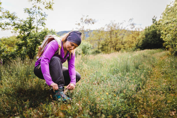 Female hiker ties shoelaces