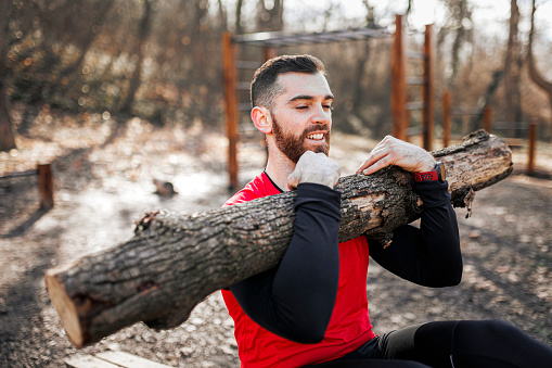 Sporty man doing sit-ups exercise during outdoors workout