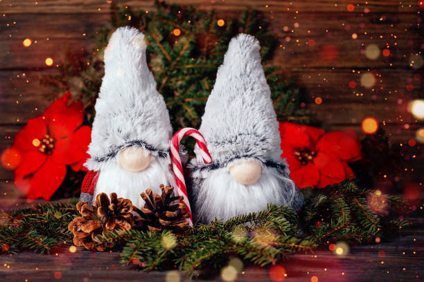 Merry Christmas. Christmas composition with gnome and festive decorations on wooden background. Christmas or New Year greeting card. Noel gnome background. Christmas symbol. Happy Holidays.