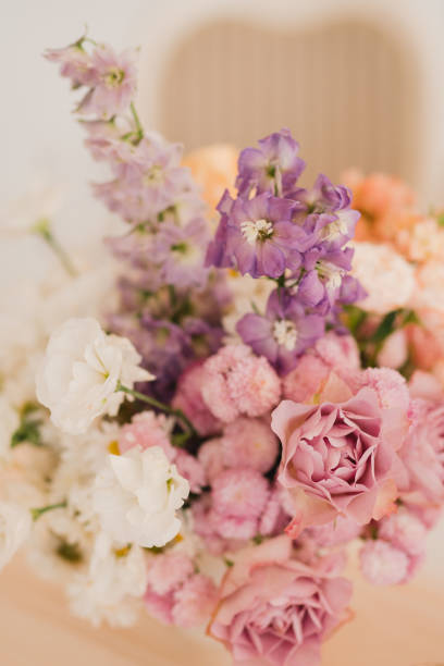 istock Table setting at the wedding reception. Floral compositions with beautiful flowers and greenery, candles, laying and plates on a decorated table. 1396856435