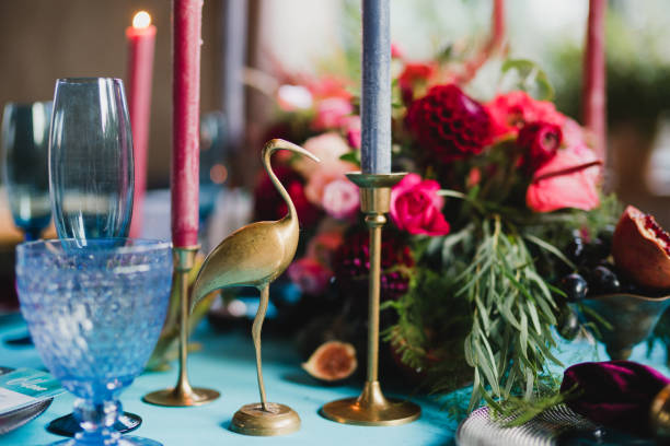 istock Table setting at the wedding reception. Floral compositions with beautiful flowers and greenery, candles, laying and plates on a decorated table. 1396859279