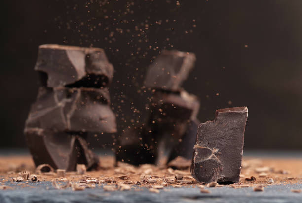 istock Broken dark chocolate and cocoa powder on a table 1396860353
