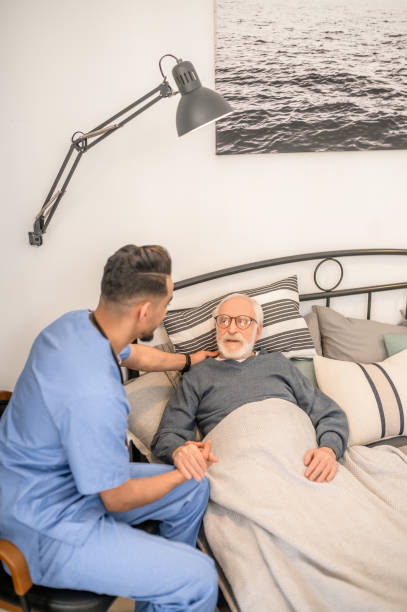 istock Male physician visiting an ill aged man 1396861255