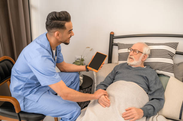 istock General practitioner examining a bedridden man during the home visit 1396861257