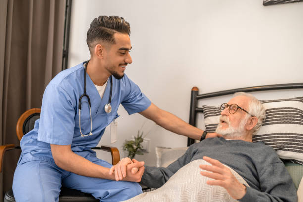 istock Smiling friendly doctor visiting a bedridden patient 1396861259