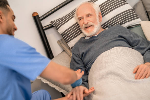 istock Elderly patient undergoing an in-home physical therapy session 1396861272
