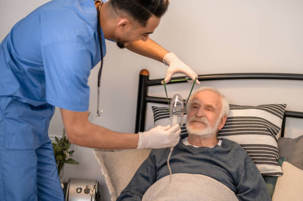 istock Nurse preparing an aged man for oxygenation 1396861318
