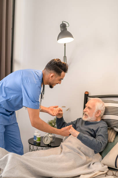 istock In-home nurse assisting the patient into a sitting position 1396861323