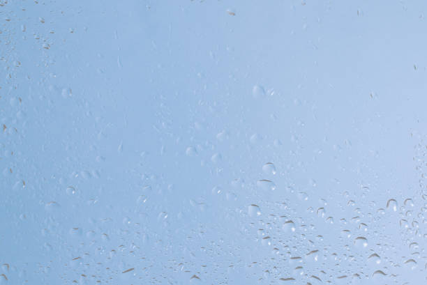 Blue backgrond with water drops. Wet glass.  Copy space.