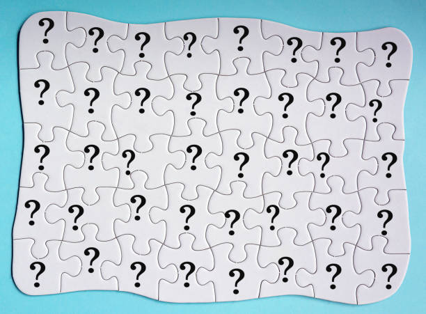 istock Set of 40 puzzle pieces with question mark isolated on blue background. 1396862406