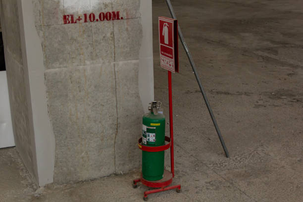 Green fire extinguisher and symbol of fire protection on construction site