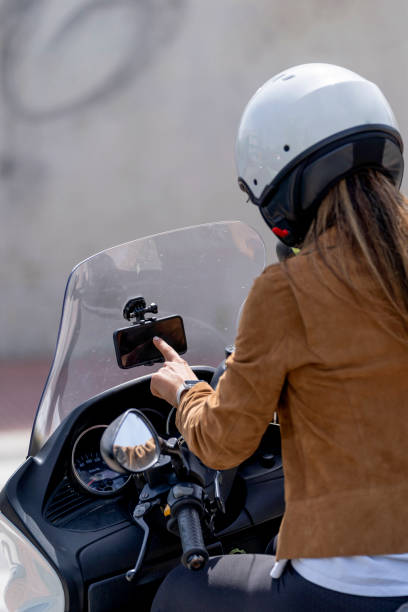 istock Woman manipulating GPS phone on motorcycle 1396862646