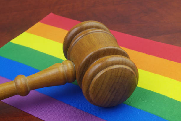 istock Wooden judge gavel on LGBT flags. 1396863356