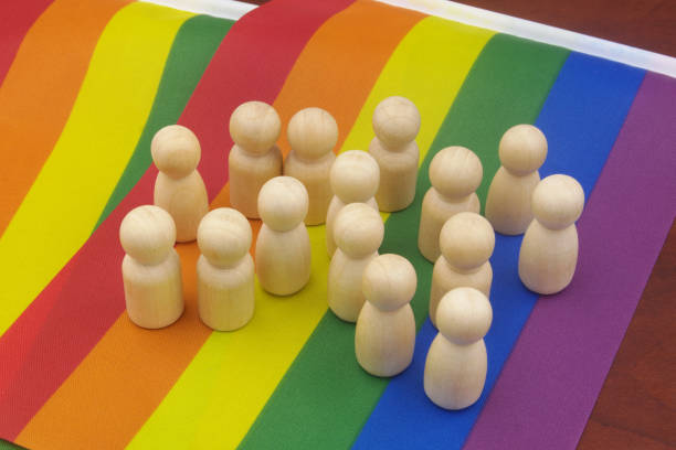 istock Wooden people figures on LGBT pride flag. 1396864665