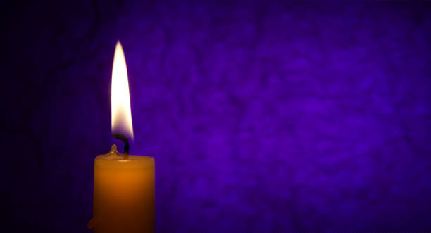 istock Candle flame in the dark red background 1396864770