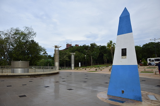 Puerto Iguazu, Argentina. Argentine obelisk of the three frontiers: Brazil, Argentina and Paraguay. Blue and white obelisk located on Hito Tres Fronteras on the Triplice Fronteira.
