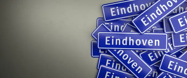 Multiple Eindhoven city limit signs on a heap. Eindhoven is the fifth largest city in the Netherlands. The typical blue city limit sign for cities in the Netherlands. Web banner format with copy space.