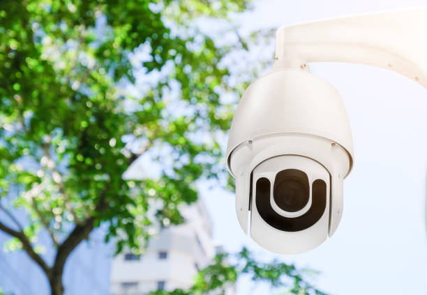 istock Modern public CCTV camera on a electric pole with blurred natural background. Intelligent reccording cameras for monitoring all day and night. Concept of surveillance and monitoring with copy space. 1396868796