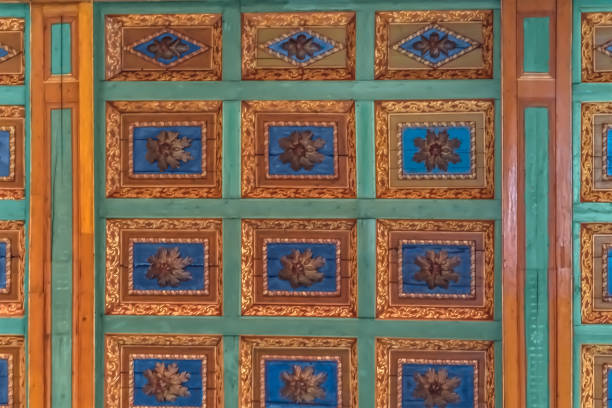 Shkoder, Albania - June 21, 2021: Traditional pattern on the ceiling of St. Stephens Cathedral in Shkodra. Golden blue floral geometric real texture created from wood