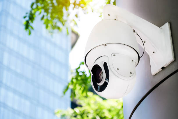 istock Modern public CCTV camera on a electric pole with blurred building and natural background. Reccording cameras for monitoring all day and night. Concept of surveillance and monitoring with copy space. 1396869445