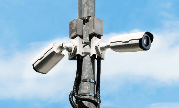 istock Modern public 360 degree CCTV cameras with bright sky background. Intelligent reccording cameras for monitoring all day and night. Concept of surveillance and monitoring with copy space. 1396869533