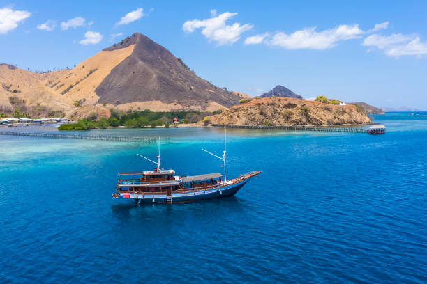 aerial view of beaches and tourist boat sailing in kelor island, flores island, indonesia - komodo ejderi stok fotoğraflar ve resimler