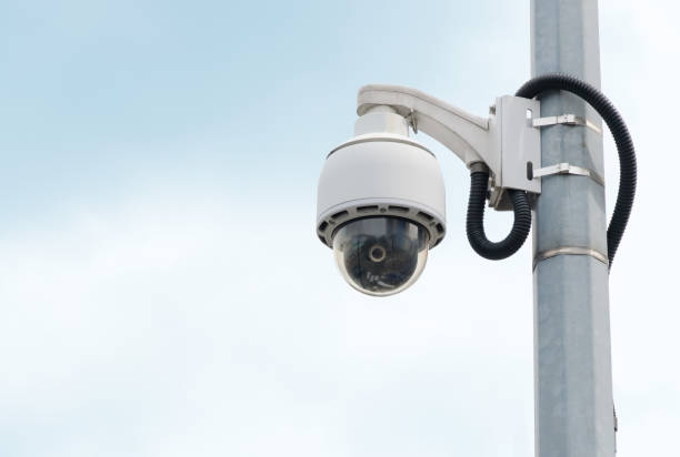 istock Modern public 360 degree CCTV cameras with bright sky background. Intelligent recording cameras for monitoring. Concept of surveillance and monitoring with copy space. 1396873209