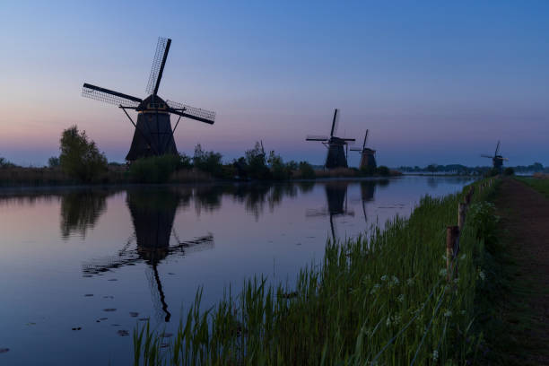 istock Traditional Dutch windmills with a colourful sky just before sunrise in Kinderdijk, The Netherlands 1396874149