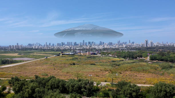 istock 3d rendering,Massive ufo Flying saucer hovering over large city Aerial view 1396874538