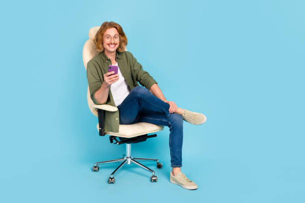 istock Full length body size view of attractive cheerful guy sitting using device gadget smm app isolated over pastel blue color background 1396875644