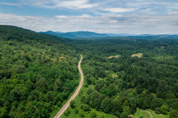 istock Croatia Landscape with Forest and Mountain in Background. Cloudy Sky with Railway 1396875921