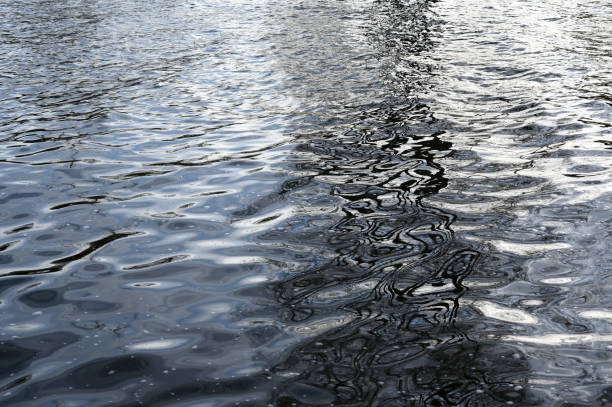 water surface with waves and reflections stock photo