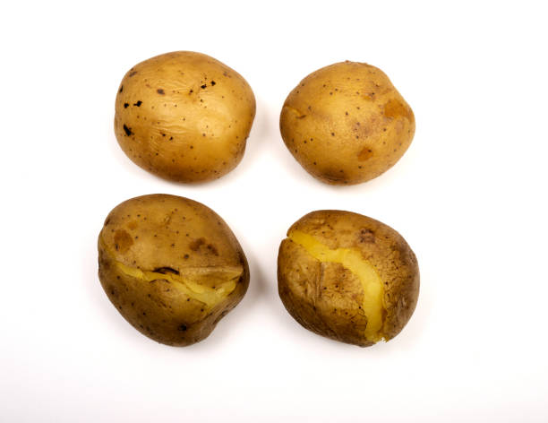 istock four boiled potatoes in their skins on a white 1396880005