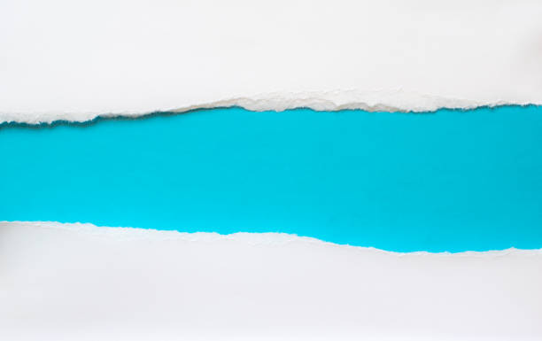 istock pieces of torn paper on a blue background. copy space 1396880403
