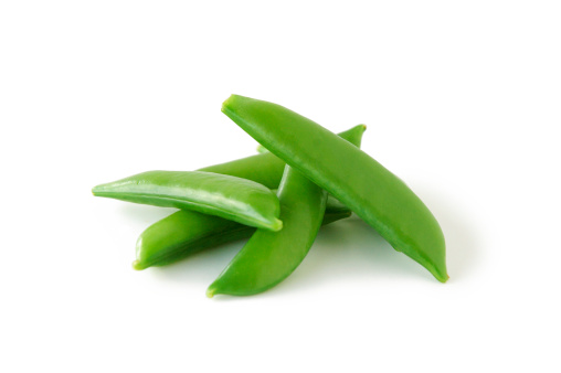 A small pile of sweet and succulent sugar snap peas on a white background.