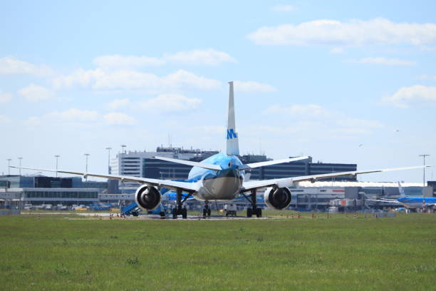 Amsterdam Airport Schiphol, The Netherlands -  May 5th 2020: Airport in Corona lockdown. Limited air traffic keeps planes grounded. KLM Boeing