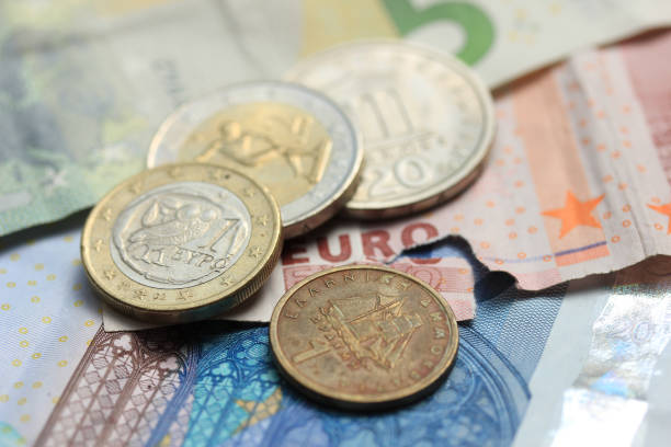 istock Greek coins on euro notes 1396882860